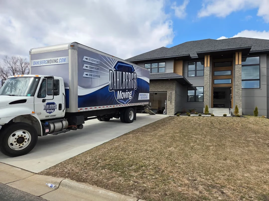 Dahlberg's Moving truck parked outside a modern Minnesota home